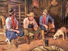 three men are sitting on the ground in front of a barn with a dog and a cow