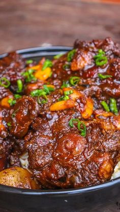 a close up of a plate of food with meat and vegetables on top, sitting on a table