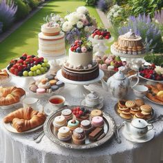 a table topped with lots of different types of cakes and pastries on top of plates