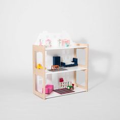 a toy doll house with furniture and accessories on the shelves in front of a white background