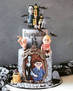 a halloween themed cake with figurines on top