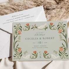 the wedding stationery is laid out on top of an unmade bed with fur