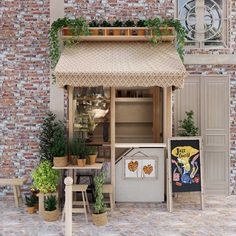 an outdoor kitchen with potted plants on the outside