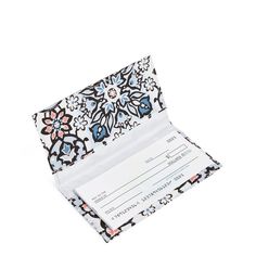 a card case with a floral design on the front and side, open to show an id