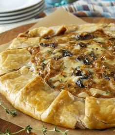 a pizza sitting on top of a wooden cutting board