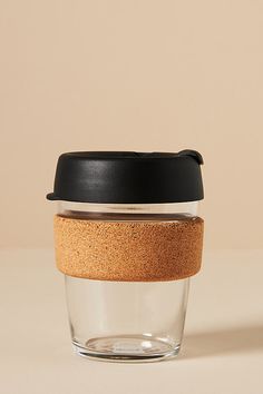 there is a glass cup with a cork lid