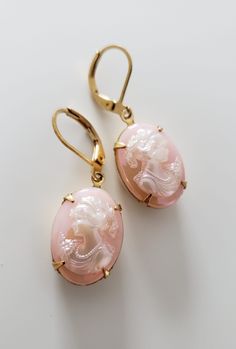 Rose engraved crystals with hidden design. Embedded in a polished gold frame. Luxury Vintage Pink Earrings, Elegant Cameo Jewelry For Wedding, Elegant Pink Jewelry With Engraving, Elegant Pink Engraved Jewelry, Elegant Engraved Pink Jewelry, Gold Intaglio Jewelry For Evening, Elegant Cameo Jewelry, Elegant Oval Cameo Jewelry, Luxury Gold Cameo Jewelry