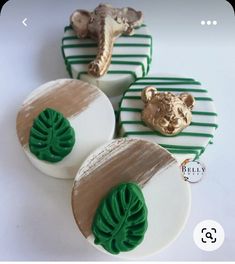 three cookies decorated with green and gold decorations