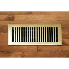 an air vent on the side of a wooden wall with black and white striped design