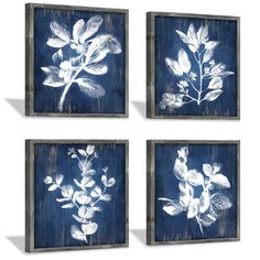 three blue and white floral paintings on wood