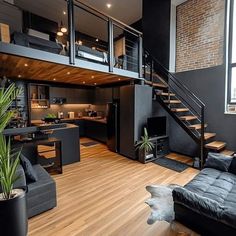 a living room filled with furniture next to a wooden floor and staircase leading up to a loft