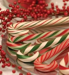 some candy canes are sitting on a glass plate