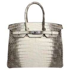 Up for sale is the Holy Grail Hermès Birkin 35 Diamond Himalayan. The Diamond Himalyan is the pinnacle of luxury and elegance, celebrated as one of the rarest and most exquisite handbags in the world. Crafted from Niloticus crocodile leather, the bag features a color gradient that ranges from a rich smoky gray to a pearly white, reminiscent of the majestic Himalayas, which inspired its name. What elevates this Birkin to a level of pure opulence is the dazzling hardware: the clasp, lock, and key are crafted from 18-karat white gold, and are adorned with sparkling, flawless diamonds. The combination of radiant diamonds set against the refined gradient of the leather makes this handbag a true masterpiece. With only a few pieces made every year the Diamond Himalayan Birkin is more than just a Most Expensive Hermes Bag, Hermes Ostrich Birkin, Himalayan Birkin, Rich Bags, Hermes Crocodile Bag, Birken Bag, Status Symbol, Hermes Birkin 35, Flawless Diamond