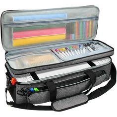 an open laptop bag with pens, markers and pencils in the bottom compartment on a white background