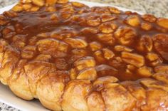 a pastry covered in caramel sauce on top of a white plate