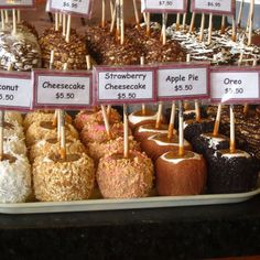 an assortment of desserts on display for sale