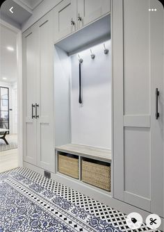 a room with some white cabinets and drawers