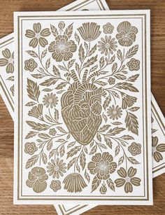 three brown and white cards with an intricate design on the front, two are blank