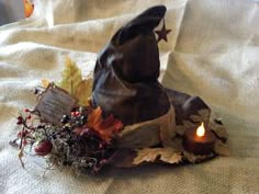 a witches hat and candle on a bed