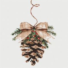 a cross stitch christmas ornament with pine cones and berries hanging from it's center