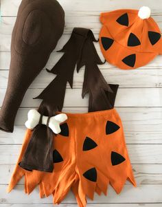 three halloween costumes made to look like pumpkins