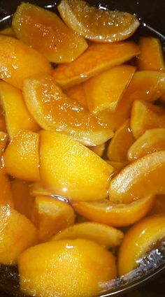 oranges are being cooked in a pan on the stove