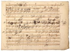 an old sheet with music notes written in cursive writing on it's edges