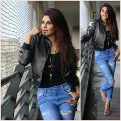 a woman wearing ripped jeans and a leather jacket