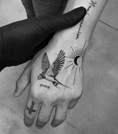 two people with tattoos on their hands and one is holding the other's hand