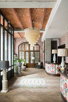 a living room filled with furniture and lots of windows