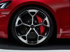 the front wheel of a red sports car