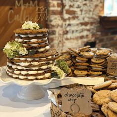 a table topped with lots of cookies covered in frosting next to a pile of cookies