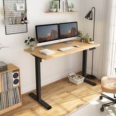 a computer desk with two monitors sitting on top of it next to a book shelf