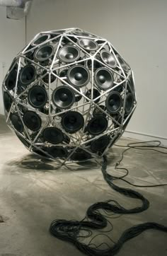 a large metal object with speakers on it's sides and wires in the middle