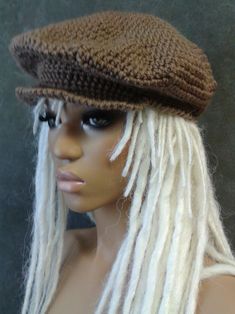 a mannequin head wearing a brown hat with white dreadlocks