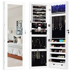 an open closet with jewelry hanging on the doors