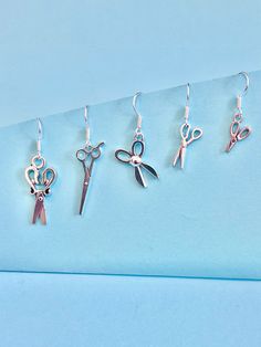 Scissor, Dressmaking, hairdressing fun and funky dangler earrings Perfect for the dressmaker, hairdresser you know or the school teacher you love. The hook is made of plated sterling silver to protect your ears and Scissors are made of Tibetan silver, available in 5 Different styles. They come well presented and wonderful for a present for a friend, family, your loved one or a treat for yourself.  Thank you for taking the time to look at my earrings and please visit my shop for more original des Scissor Earrings, Scissors Earrings, Saxophone Earrings, Scissors Necklace, The Dressmaker, Silver Fish-shaped Earrings With Fish Hooks, Hairdressing Scissors, Dangler Earrings, Le Crochet