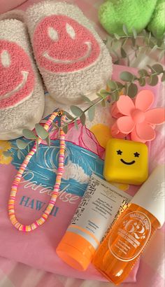 the contents of a diaper laid out on top of a pink blanket with flowers