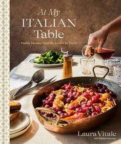 a cookbook with an image of food on the cover and in front of it