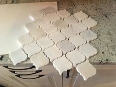 several pieces of white tile sitting on top of a counter