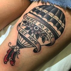 a woman with a tattoo on her thigh that says there's no place like home