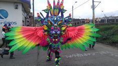 a man in colorful costume walking down the street