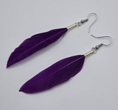 This elegant pair was authentically handcrafted in the Upper Peninsula of Michigan on March 01, 2023. Handmade with a single purple duck feather that was set with jewelry glue into a .925 Sterling Silver End Crimp. The earrings was finalized with a nickel free silver ear wire.  Each earring is approximately 1/2" wide and 3 1/4" long from top of ear wire to bottom of feather.  Thank you for viewing! 🪶 Elegant Purple Tassel Earrings, Purple Dangle Tassel Earrings, Adjustable Silver Earrings With Feathers, Adjustable Silver Feather Earrings, Adjustable Blue Feather Earrings, Boho Feathers, Feather Jewelry, Feather Earrings, Violet