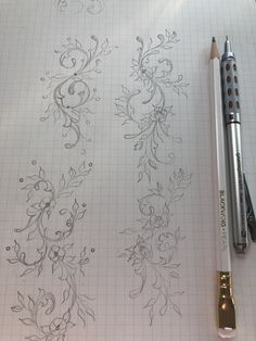 a pen and some drawings on a sheet of paper