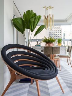 a living room filled with furniture and a plant in the middle of it's center