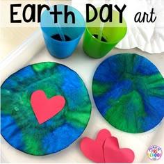 the earth day art project is made with paper plates and colored construction paper to make heart shapes