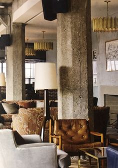 a living room filled with lots of furniture next to a fire place in a building