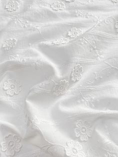 an image of white fabric with flowers on it