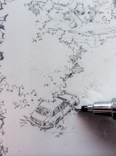 a pen is sitting on top of a piece of paper that has been drawn with ink