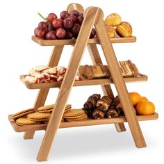 three tiered wooden trays filled with different types of food and fruit on top of each other